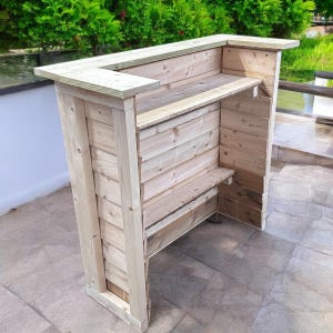 May include: A wooden bar counter with a natural finish. The counter has a shelf and a small ledge. The counter is made of unfinished wood planks.