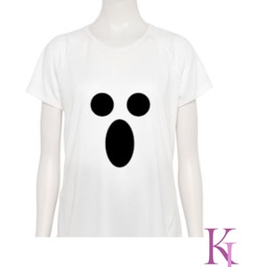 May include: White t-shirt featuring a black ghost face design. The design includes two black circles for eyes and a large oval for the mouth. The shirt is displayed on a mannequin. The text "Katie Jane Designs" is in the lower right corner.