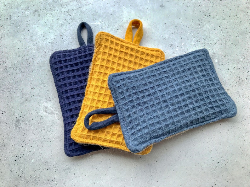 May include: Three pot holders, one yellow and two blue, with a waffle-like texture. The pot holders are made of a soft, absorbent material and are perfect for protecting your hands from hot surfaces.
