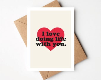 May include: A card with a red heart and the text "I love doing life with you."