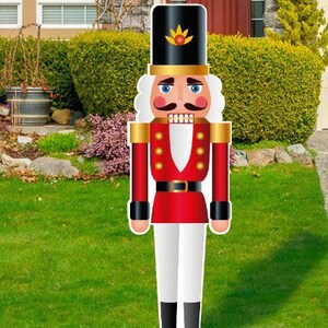 May include: A large, red and white nutcracker figurine with a black hat and a gold belt. The nutcracker has a mustache and a white beard.