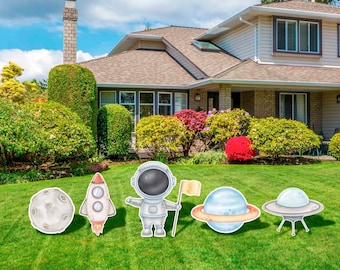 May include: A set of five outdoor yard decorations featuring a rocket, astronaut, moon, flying saucer, and a planet with rings. The decorations are painted in a watercolor style with a white background.