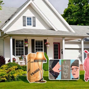 May include: A set of Home Alone themed yard signs featuring a large cardboard box with a leg lamp inside, a sign with the text "I Triple Dog Dare Ya!" and a character dressed in a pink bunny costume.