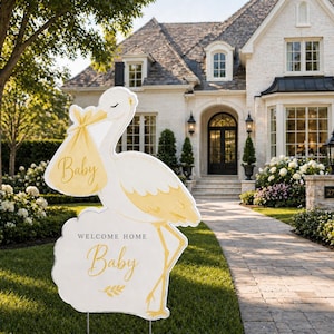 May include: A white and yellow stork-shaped yard sign with the word "Baby" on a pouch and on the sign. The sign reads "Welcome Home Baby" and is placed in a front yard.