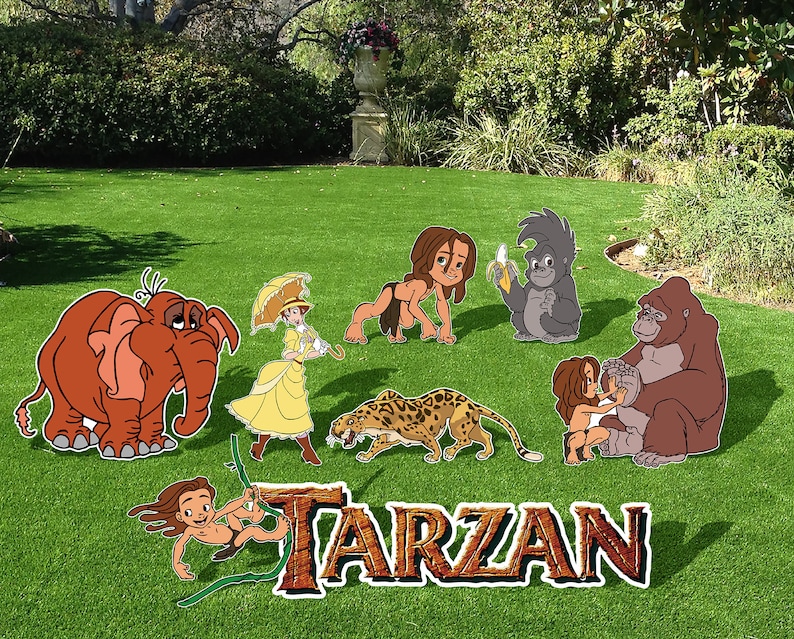 May include: A set of cardboard cutouts featuring characters from the Disney movie Tarzan. The characters include Tarzan, Jane, Terk,  Tantor,  and  Kerchak. The cutouts are on a green grassy lawn with the word "TARZAN" in large letters in the foreground.