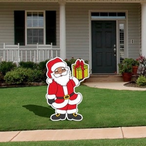 Black Santa Claus holding present cut out or yard sign