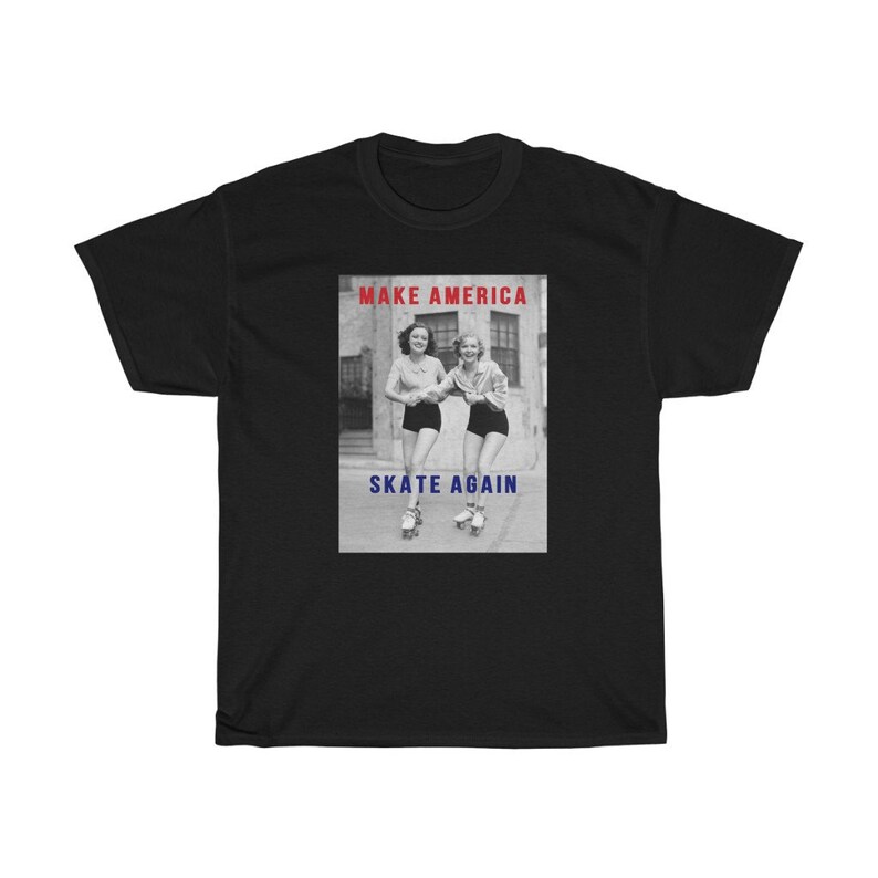 May include: Black t-shirt featuring a vintage black and white image of two women roller skating. The image is framed with the text "MAKE AMERICA" in red and "SKATE AGAIN" in blue.