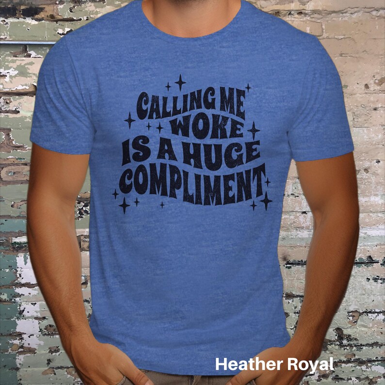 May include: A blue t-shirt with the text "Calling me woke is a huge compliment" in black lettering.