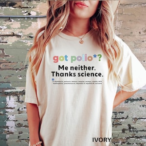 May include: A white t-shirt with the text "got polio*? Me neither. Thanks science." printed in rainbow colors. The text is followed by a list of diseases that vaccines protect against.