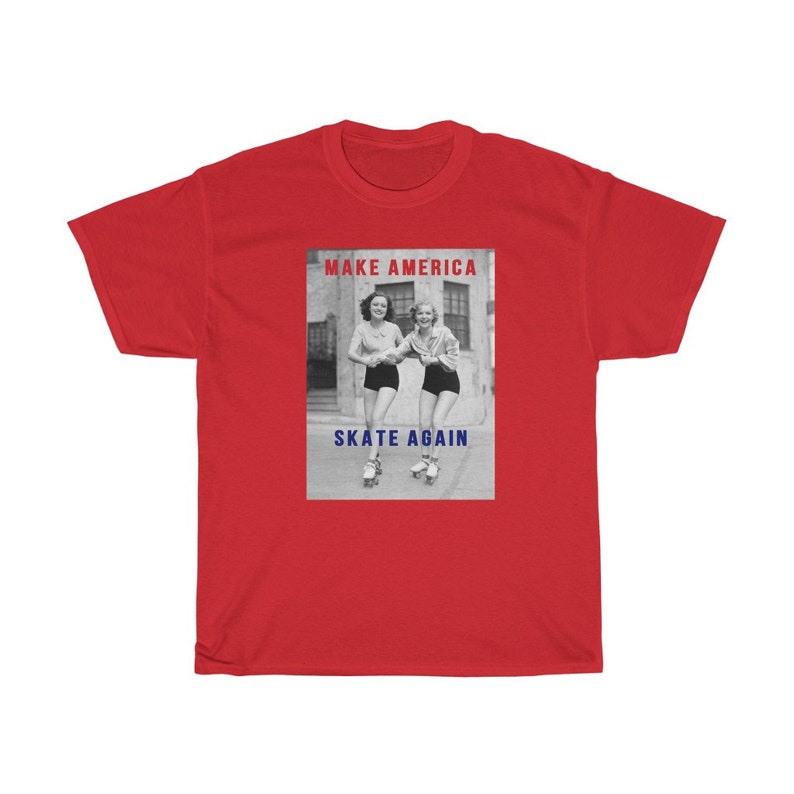 May include: A red t-shirt featuring a black and white image of two women roller skating. The image has the text "MAKE AMERICA" in red and "SKATE AGAIN" in blue.