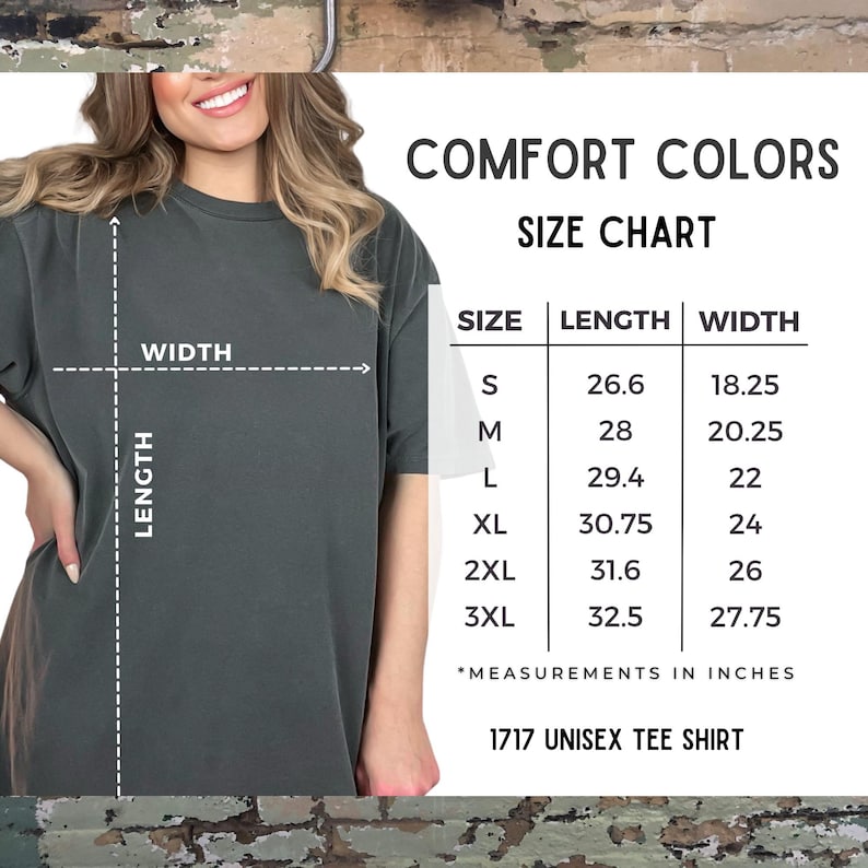 Puede incluir: Una camiseta unisex gris oscuro con una tabla de tallas. La tabla muestra las medidas en pulgadas para las tallas S a 3XL. Tambi&eacute;n se ve el texto "COMFORT COLORS" y "1717 UNISEX TEE SHIRT".