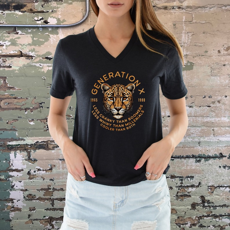 May include: Black v-neck t-shirt with a graphic of a leopard and the text "GENERATION X 1965 - 1980 LESS CRANKY THAN BOOMERS LESS WHINY THAN MILLENIALS COOLER THAN BOTH"
