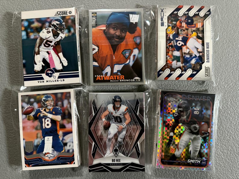 May include: Six collectible football trading cards featuring Denver Broncos players. Cards include Von Miller, Atwater, DiMarcus Ware, Peyton Manning, Bo Nix, and Rod Smith. Each card is in a protective sleeve.