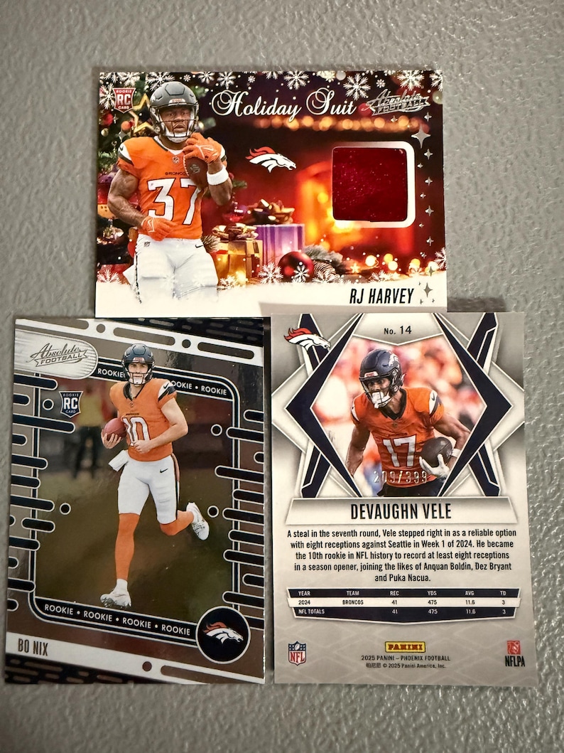 May include: Three football trading cards featuring Denver Broncos players. One card is a "Holiday Suit" card with RJ Harvey. Another card features Bo Nix. The third card shows Devaughn Vele, with stats and a limited edition number.