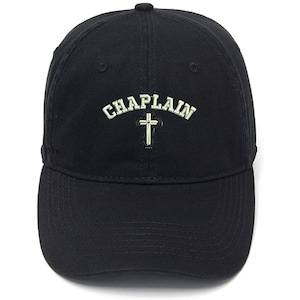May include: Black baseball cap with the word "CHAPLAIN" embroidered in white with a white cross underneath.