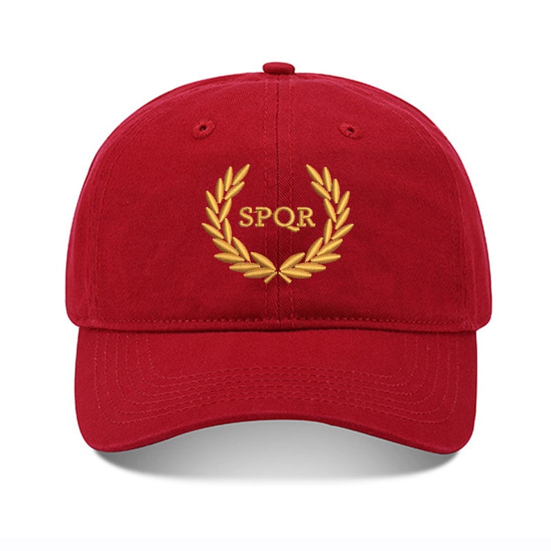 May include: A red baseball cap with a gold embroidered laurel wreath and the text "SPQR" in the center.