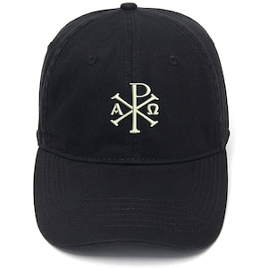 May include: A black baseball cap featuring a white embroidered symbol of a cross with the letters Alpha and Omega on either side of the cross. The symbol is known as the Chi Rho.