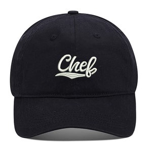 May include: A black baseball cap with a white embroidered word "Chef" on the front.