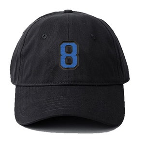 May include: A black baseball cap with a blue number 8 embroidered on the front.