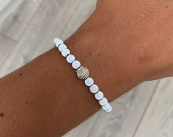 White miracle bead bracelet with shell charm