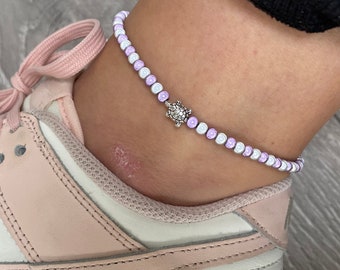 Violet and white miracle bead anklet with turtle charm