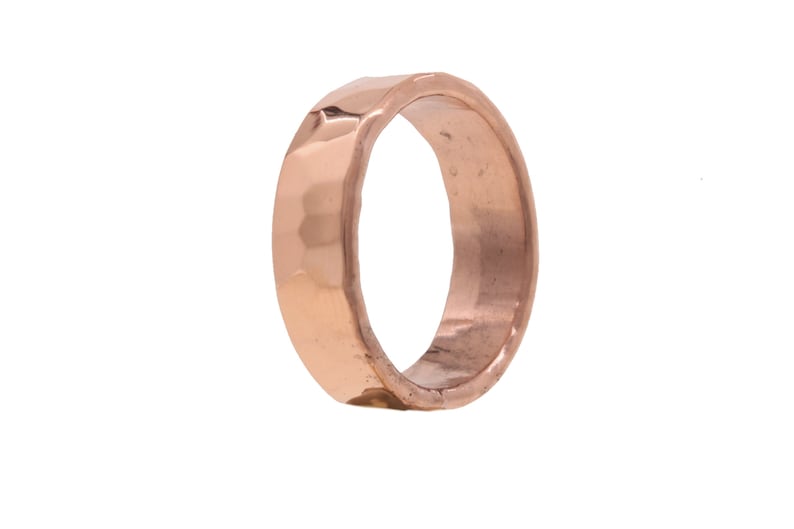 May include: A hammered copper ring with a wide band.