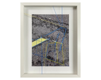 May include: A framed abstract art print with a gray background and blue and yellow lines forming geometric shapes.