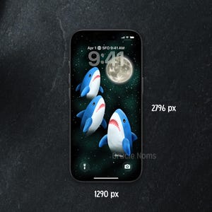 May include: A smartphone displays a whimsical wallpaper featuring three cartoon sharks swimming in a starry night sky with a full moon. The time is 9:41 AM, April 1st, SFO.