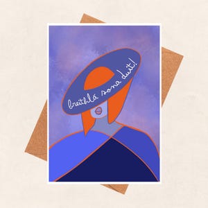 May include: A purple and blue watercolour background with a woman wearing a large, blue hat with the text "breithla sona duit!" written on it. The woman has red hair and is wearing a blue and black dress.