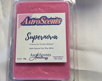 May include: A pink soy wax melt in a clear plastic container. The label reads "AstroScents Supernova" and "A Scent for Tension Release". It also says "100% Natural Soy Wax Melts" and "Handcrafted in New Jersey".
