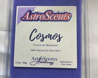 May include: A purple soy wax melt in a clear plastic container. The label reads "Astro Scents Cosmos "A Scent for Meditation" 100% Natural Soy Wax Melts 2.4oz. 68g AstroScents Aromatherapy Handcrafted in New Jersey"
