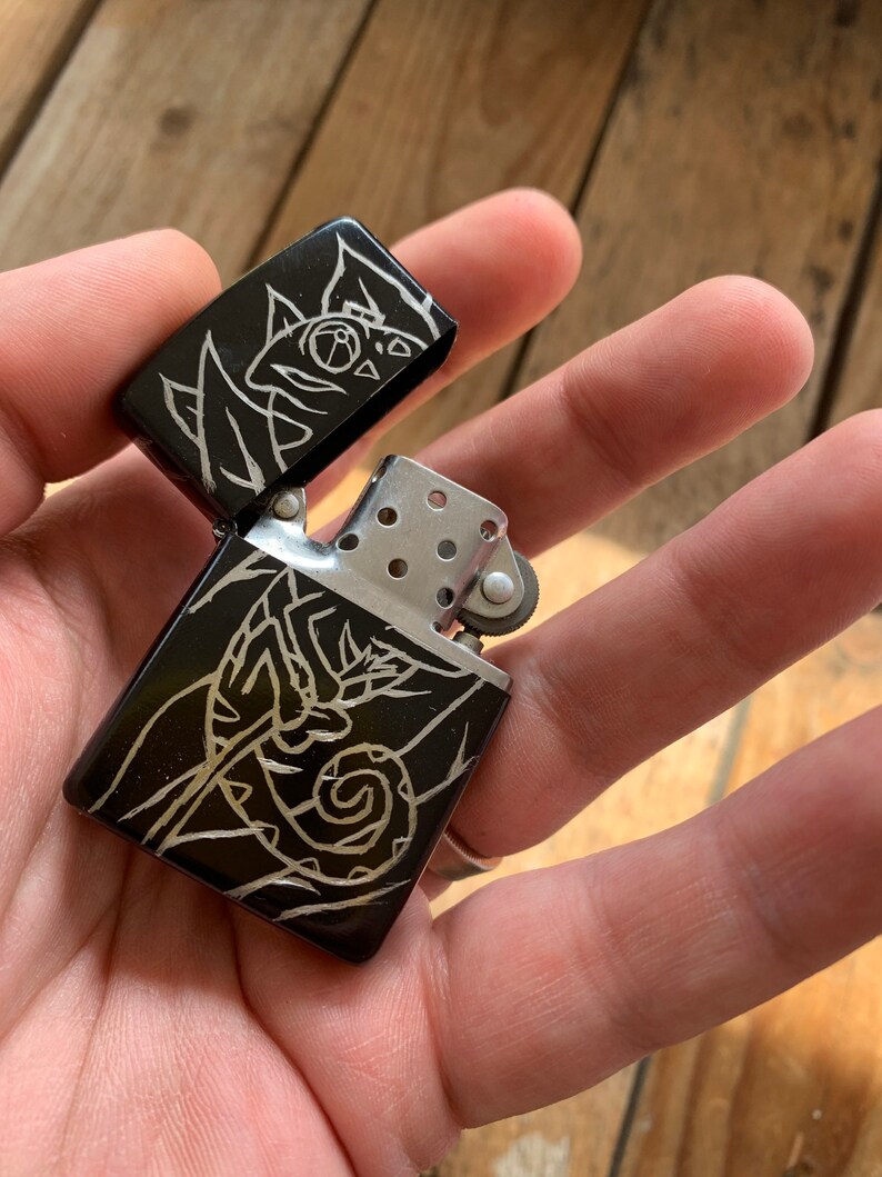 scrawled with a wood screw. A \u201cHobo Engraved\u201d Metal Chameleon Lighter