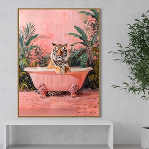 May include: A tiger sits in a pink bathtub surrounded by lush green tropical plants. The bathtub is overflowing with water and the tiger is looking directly at the viewer.