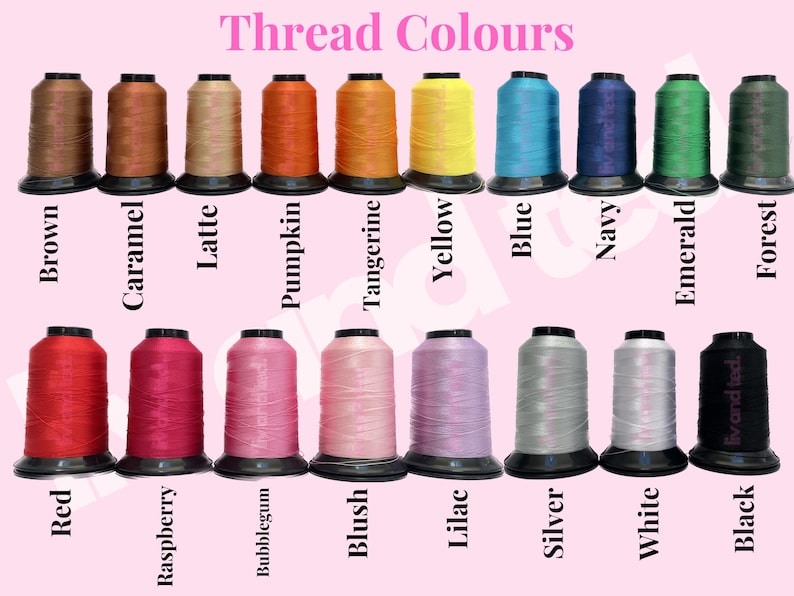 May include: A collection of seventeen spools of embroidery thread arranged in two rows against a light pink background. The spools are labeled with color names including Brown, Caramel, Latte, Pumpkin, Tangerine, Yellow, Blue, Navy, Emerald, Forest, Red, Raspberry, Bubblegum, Blush, Lilac, Silver, White, and Black.