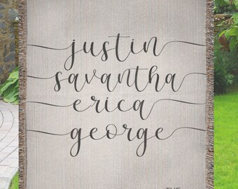 May include: A woven throw blanket with the names "Justin", "Savannah", "Erica", and "George" written in cursive script. The text "THE STANLEYS" is printed below the names.