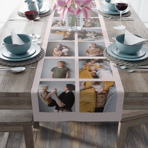 May include: A pink table runner with a white border features a collage of nine photos of children and families. The photos are arranged in a grid pattern and are printed in a high-quality, glossy finish.