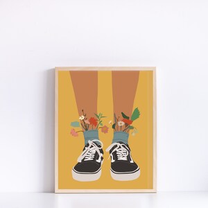 May include: A pair of black canvas shoes with blue socks and colourful flowers growing out of the socks. The shoes are on a yellow background.