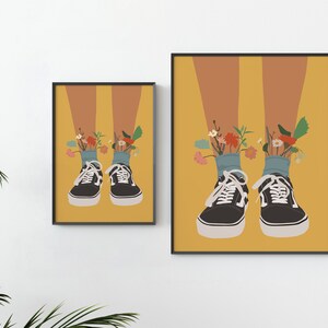 May include: A pair of black canvas trainers with white laces and a yellow background. Flowers are growing out of the top of the trainers.