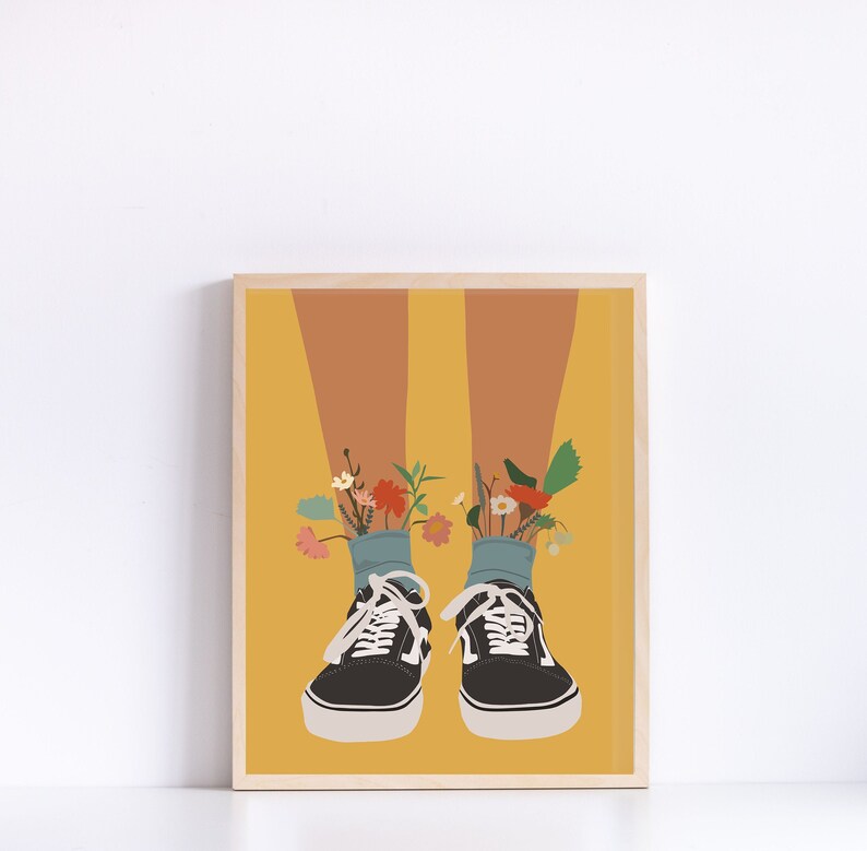 May include: A pair of black canvas shoes with blue socks and colourful flowers growing out of the socks. The shoes are on a yellow background.