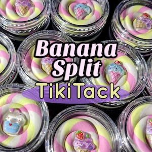 May include: Close-up of several small, clear jars filled with a swirl of pink, yellow, and white clay, topped with miniature ice cream cone charms. The text "Banana Split TikiTack" is displayed across the image.