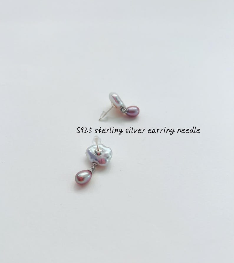 May include: A pair of silver earrings with a single, irregular-shaped pearl and a smaller, round pearl dangling from each earring. The text "S925 sterling silver earring needle" is visible below the earrings.