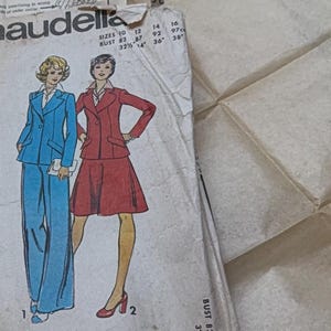 May include: A vintage Maudella multi-size printed sewing pattern envelope featuring illustrations of a blue blazer with matching trousers and a red blazer with a matching skirt. The text reads BLOUSE NOT INCLUDED and lists sizes 10 through 16.