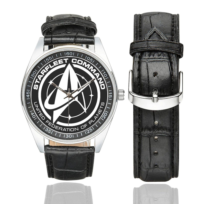 Close up of Starfleet Command logo on Star Trek watch face.