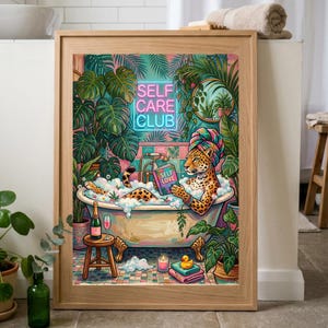 May include: A framed art print featuring a leopard in a bathtub surrounded by lush greenery. The leopard, wearing a towel, reads a book titled "Self Love." A neon sign reads "Self Care Club." A bottle of champagne and a glass sit on a small stool.