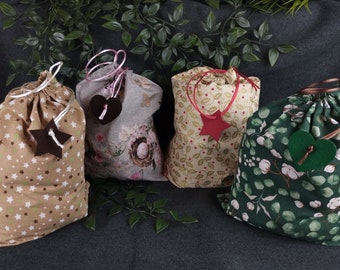 handmade gift bags with drawstring in different sizes and colors.