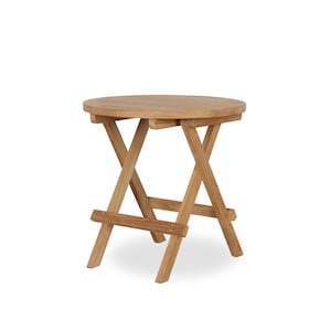 May include: A round, light brown wooden folding side table. The table has a circular top and a crisscross leg design. The table is made of natural wood and is suitable for outdoor or indoor use.