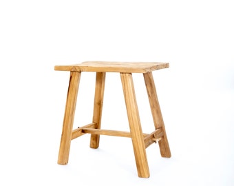 May include: A simple wooden stool with a rectangular seat and four legs. The stool is made of natural wood and has a rustic look.