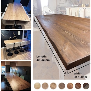 May include: A large, rectangular wooden table with a natural edge. The table is stained a warm brown colour and appears to be made of solid wood. The length ranges from 40-260cm, and the width is 30-120cm. Several images show the table in different settings.
