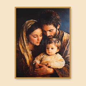 May include: A framed painting shows a family of three. The mother wears a gold head covering, and the father has dark hair and a beard. They cradle a baby in a cream-coloured outfit. The artwork has a warm colour palette with a dark background.
