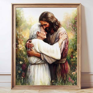 May include: A framed print depicts a tender embrace between two figures. One figure, with long brown hair and a beard, is embracing an elderly person. The artwork is set against a backdrop of soft, colorful foliage, creating a serene atmosphere.